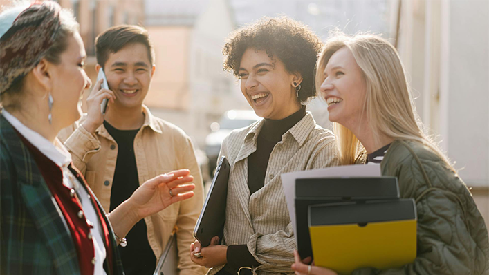 People laughing together outside of an office